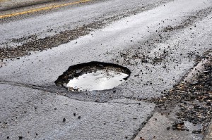 A road damaged by rain,snow, or the freeze/thaw cycle that is in need of maintenance.